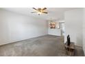 Open-concept living room with neutral carpet and seamless flow into the adjacent kitchen area at 4426 Sw 49Th Ave, Ocala, FL 34474
