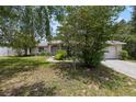 Inviting single-story home with lush landscaping, a charming front entrance, and a convenient two-car garage at 9879 Sw 38Th Ave, Ocala, FL 34476