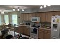 Well-equipped kitchen featuring sleek countertops, modern appliances, and a cozy breakfast nook at 32932 Crooked Oaks Ln, Leesburg, FL 34748