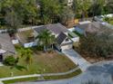 Aerial view of home with fenced yard, mature trees, and a spacious driveway on a corner lot at 1029 Evans Loop, Lake Wales, FL 33853