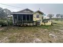 Yellow house with a screened porch and lake view at 1120 S Scenic Hwy, Lake Wales, FL 33853