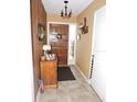 Bright entryway with wood-paneled walls and tiled flooring at 1163 Cephia St, Lake Wales, FL 33853