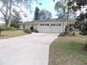 Ranch home with a two-car garage and a large driveway at 1163 Cephia St, Lake Wales, FL 33853