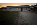 Newly painted light gray house with a blue door, and a grassy yard at 2000 Mcclellan Rd, Frostproof, FL 33843