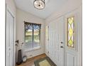 Bright entryway featuring a white door with decorative glass and a view of the golf course at 2680 Clubhouse Dr, Lake Wales, FL 33898