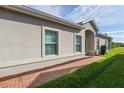 Brick walkway leads to the entrance of a tan house with red mulch at 3020 Caneel St, Winter Haven, FL 33884