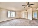 Bright living room featuring a large window and ceiling fan at 337 Swingle St, Frostproof, FL 33843