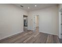 Bright and airy living room with wood-look floors and access to other rooms at 412 2Nd Sw St, Winter Haven, FL 33880