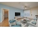 Bright living room featuring modern decor, light blue accent wall, and contemporary furniture at 5011 Hemingway Cir # 5011, Haines City, FL 33844