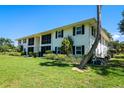 Condo building with lush landscaping surrounding the property at 711 Springer Dr # 2, Lake Wales, FL 33853