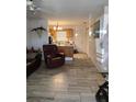 Open concept living room showcases tile floors, adjacent kitchen, and a comfortable seating area at 1402 Thousand Roses Dr. W. # 1402, Lake Wales, FL 33853