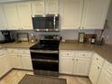 Well-equipped kitchen featuring stainless steel appliances and white cabinets at 1893 N Lake Reedy Blvd, Frostproof, FL 33843