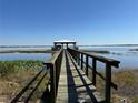 Scenic view of the lake featuring a private dock with a charming gazebo at 1893 N Lake Reedy Blvd, Frostproof, FL 33843