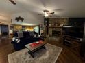 Cozy living room featuring a stone fireplace and comfortable seating area with hardwood floors at 2134 R E Byrd Rd, Frostproof, FL 33843