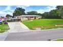 Charming single-story home with a carport, manicured lawn, and a convenient circular driveway at 301 S Clinch Lake Blvd, Frostproof, FL 33843