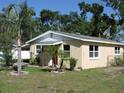 Well-maintained home displaying a neat exterior, complemented by a green lawn and manicured landscaping at 332 Jackson St, Lake Wales, FL 33859