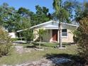 Welcoming home showcasing the front yard with mature landscaping and a cozy facade at 332 Jackson St, Lake Wales, FL 33859