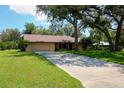 Charming single-story home with a two-car garage and mature landscaping at 3567 Red Oak Ct, Lake Wales, FL 33898