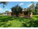 Inviting single-story home with mature landscaping and a two-car garage at 3567 Red Oak Ct, Lake Wales, FL 33898