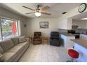 Cozy living area with neutral tones, tile flooring, and an open flow to the kitchen area at 711 Springer Dr # 9, Lake Wales, FL 33853