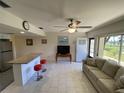 Bright living room with tile floors, granite breakfast bar, and a view of the landscaped outdoors at 711 Springer Dr # 9, Lake Wales, FL 33853