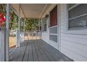 Inviting covered front porch showcasing wood flooring and exterior details at 720 S Orange Ave, Bartow, FL 33830