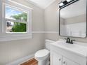 Cozy bathroom with a new vanity, updated fixtures, and a modern mirror at 111 D St, Frostproof, FL 33843