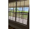 View from the window shows the wooden porch and grass at 111 D St, Frostproof, FL 33843