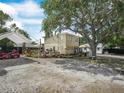 Backyard featuring deck, large shade tree and ample space for vehicles at 1351 Smokey Rd, Lake Wales, FL 33859