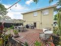 Backyard deck complete with a grill, patio furniture and lush landscaping at 1351 Smokey Rd, Lake Wales, FL 33859