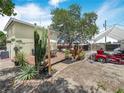 View of the backyard with deck, mature plantings and plenty of parking at 1351 Smokey Rd, Lake Wales, FL 33859