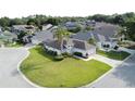 An aerial view of a home showcasing its well-manicured lawn in a friendly residential neighborhood at 2200 Mallory Cir, Haines City, FL 33844