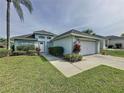 Charming single-Gathering home with a well-manicured lawn, a two-car garage, and lovely landscaping at 2200 Mallory Cir, Haines City, FL 33844