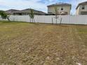 A spacious, fenced backyard featuring young trees planted along the perimeter at 2655 Swooping Sparrow Dr, Harmony, FL 34773