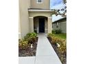 Inviting front porch with decorative plants and a clear walkway to the entrance at 2655 Swooping Sparrow Dr, Harmony, FL 34773