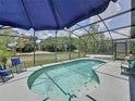 Screened-in pool area with serene blue water, surrounded by neutral pavers, perfect for relaxation at 2692 Hemingway Ave, Haines City, FL 33844