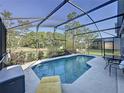 Lovely screened-in pool with serene views and outdoor seating, ideal for enjoying the outdoors at 2696 Hemingway Ave, Haines City, FL 33844