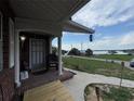Charming front porch offering a picturesque view of the adjacent lake at 400 W 4Th Ct, Frostproof, FL 33843