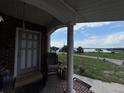 Inviting front porch offering a serene view of the nearby lake at 400 W 4Th Ct, Frostproof, FL 33843