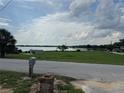 Scenic view of a tranquil lake, showcasing the property's beautiful waterfront location and open green space at 400 W 4Th Ct, Frostproof, FL 33843