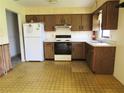 Functional kitchen boasts classic cabinets, appliances, and practical layout at 405 S Shore Dr, Eagle Lake, FL 33839