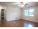 Light-filled bedroom with wood floors, closet, and large window at 4725 Kayworth Rd, Lake Wales, FL 33898