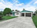 Inviting home featuring a covered carport, lush lawn, and a driveway in a quiet neighborhood at 715 S Seminole Ave, Fort Meade, FL 33841