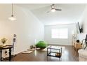 Bright living room featuring hardwood floors, a ceiling fan, and natural light from the window at 821 Orchid Springs Dr # 821, Winter Haven, FL 33884