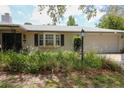 Close up of home featuring lush landscaping, and a large two-car garage at 882 Redwood Way, Lake Wales, FL 33898