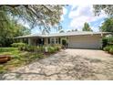Charming single-story home with a spacious driveway, two-car garage, and inviting curb appeal at 882 Redwood Way, Lake Wales, FL 33898