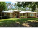 Inviting single-story home with a well-manicured lawn, American flag and attractive stone accents enhance curb appeal at 9365 Lemon Dr, Lake Wales, FL 33898