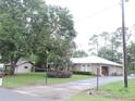 Spacious single-story house featuring a long driveway, detached garage and a well-maintained lawn at 9365 Lemon Dr, Lake Wales, FL 33898