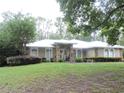 Charming single-story home with arched windows, stone accents, and inviting front yard landscaping at 9365 Lemon Dr, Lake Wales, FL 33898