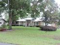 Charming single-story house featuring arched windows, stone detailing, and a well-maintained lawn at 9365 Lemon Dr, Lake Wales, FL 33898
